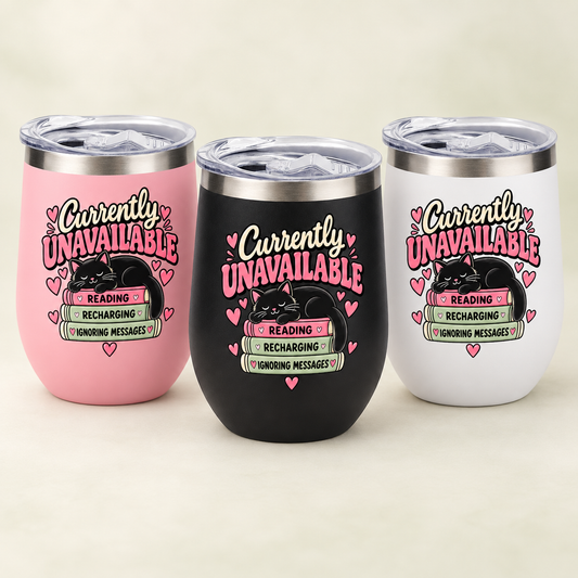 Three insulated stemless tumblers with clear lids are shown on a light beige background. The tumblers are pink, black, and white, each printed with a humorous message: 'Currently UNAVAILABLE' in pink and black script, with a black cat illustration, hearts, and a small sign that reads 'READING / RECHARGING / WONDING MESSAGES'.