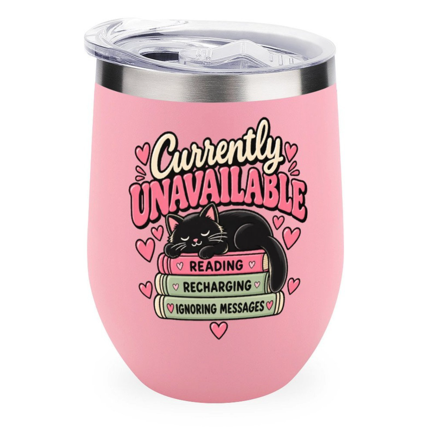 A pink insulated stemless tumbler with a clear lid, featuring a graphic of a black cat sleeping on books with the text 'Currently UNAVAILABLE' and 'READING RECHARGING IGNORING MESSAGES' on a white background.