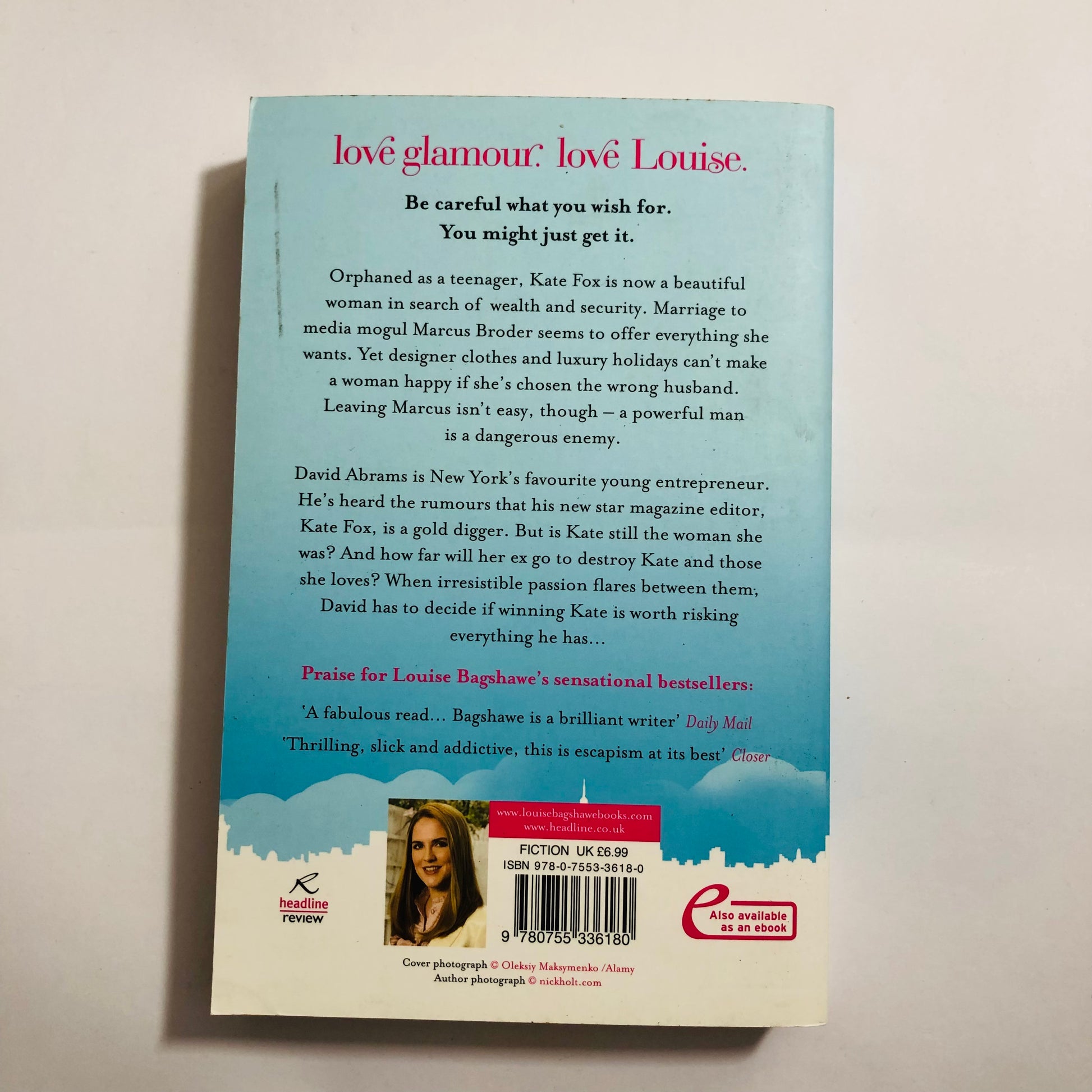 Back cover of a book with text and a barcode on a light background