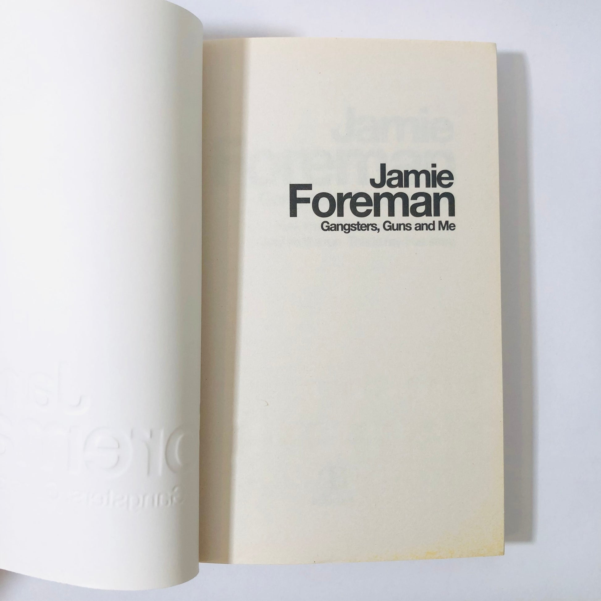 Book open to a page with 'Jamie Foreman' and 'Gangsters, Guns and Me' text on a white background