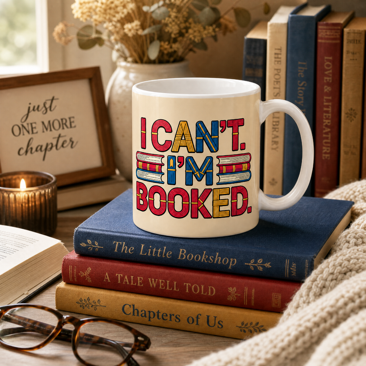 A white ceramic mug with the phrase 'I CAN'T. I'M BOOKED.