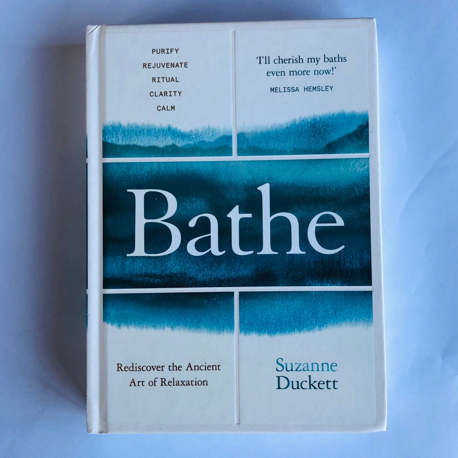 Book titled 'Bathe' by Suzanne Duckett on a light blue background