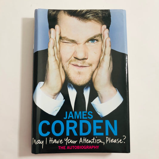 Book cover of 'May I Have Your Attention, Please?' by James Corden on a light beige background