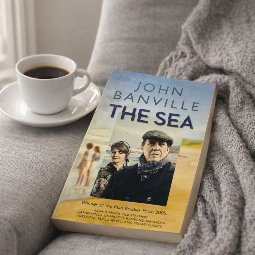 John Banville The Sea Novel on a cosy chair with a cup of coffee beside it 